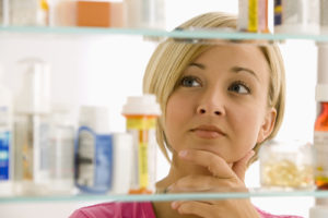 Woman Looking in Medicine Cabinet