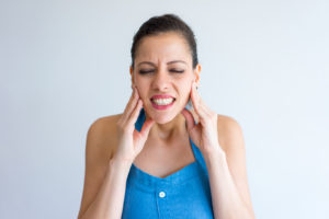 Woman with painful TMJ